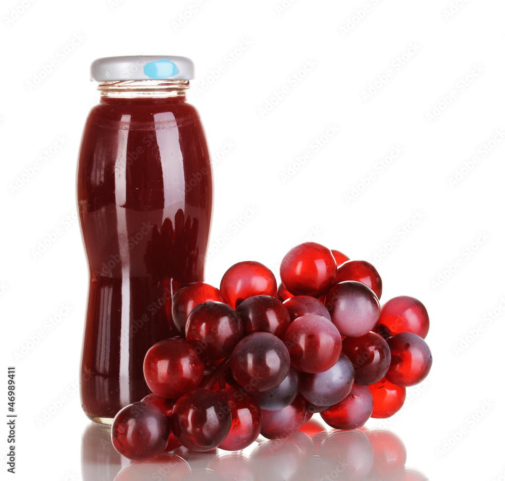 Delicious grapes juice in glass bottle and pink grapes next to