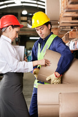 Wall Mural - Supervisor And Foreman Checking Cardboard At Warehouse