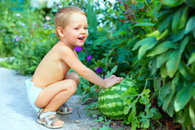 Happy Baby Boy With Big Watermelon In Summer Garden