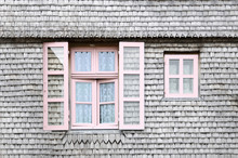 Beautiful Pink Windows On The Facade Of A Wooden House