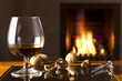 Brandy Snifter and cracked nuts by the fireplace