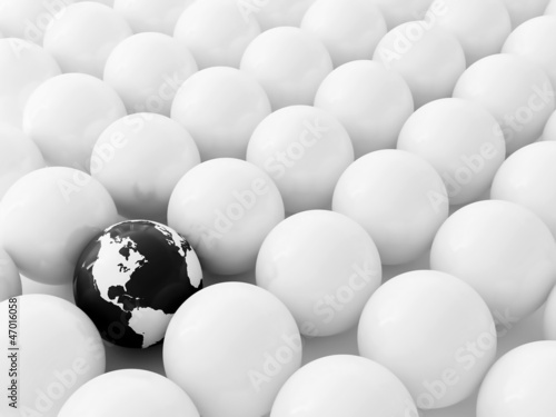 Spheres of cream color and black globe as a background