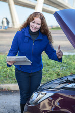 Woman Showing Thumb Up Standing In Front Of Opened Car Cowling