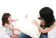 © dacasdo - mother and daughter having fun with pillows