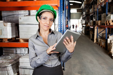 Wall Mural - Female Supervisor Using Digital Tablet At Warehouse