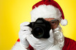 © stockyimages - Aged Santa adjusting camera lens before click