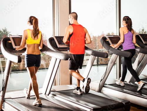 Fototapeta na wymiar People running on treadmills