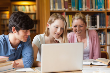 Students sitting at the library with laptop