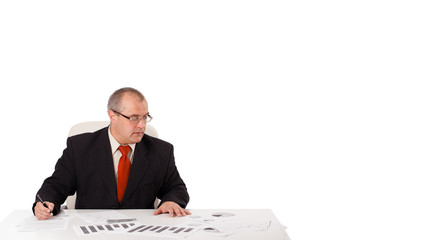 businessman sitting at desk with copy space