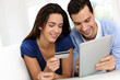 © goodluz - Young couple shopping online from home