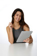 © goodluz - Smiling brunette girl websurfing with digital tablet