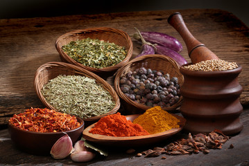 Wall Mural - Different spices over a wood background.