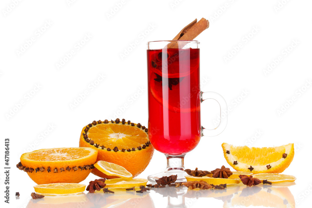 Fragrant mulled wine in glass with spices and oranges around