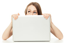 Woman Looking Out From Behind A Laptop