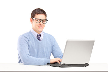 Wall Mural - Smiling male working on a laptop