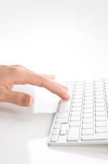 Wall Mural - Woman's hand typing on computer keyboard