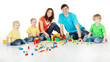 © inarik - Happy family. Parents with three kids playing blocks over white