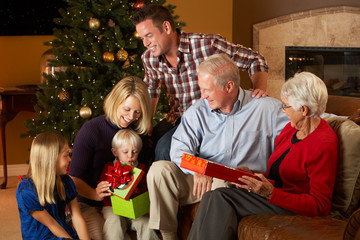 Wall Mural - Multi Generation Family Opening Christmas Presents In Front Of T