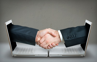 Two hands making a deal over internet