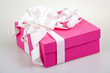 pink gift box with white ribbon and bow