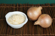 Mature onion and bowl with dried onion powder