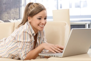 Wall Mural - Attractive woman using laptop at home