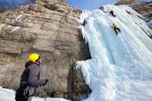 Man Climbing Frozen Waterfall