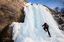 Man Climbing Frozen Waterfall