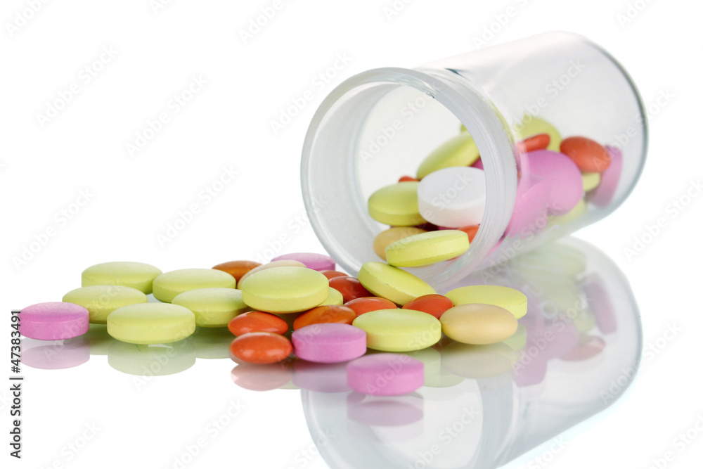 Pills in receptacle isolated on white