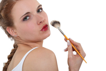 Woman applying makeup