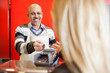 © Tyler Olson - Mature Man Accepting Credit Card From Young Woman At Supermarket