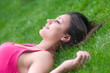 © Solid photos - Beautiful happy girl lying on the green grass