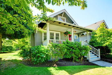 Wall Mural - Grey small house with porch and white railings.