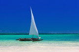 Fototapeta  - wooden boat in crisp blue water