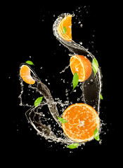 Poster - Oranges in water splash, isolated on black background