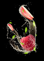 Poster -  Fresh apple in water splash on black background