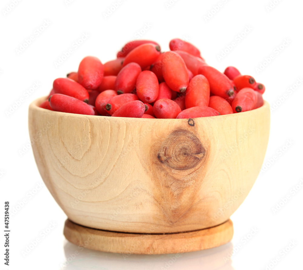 ripe barberries in wooden bowl isolated white