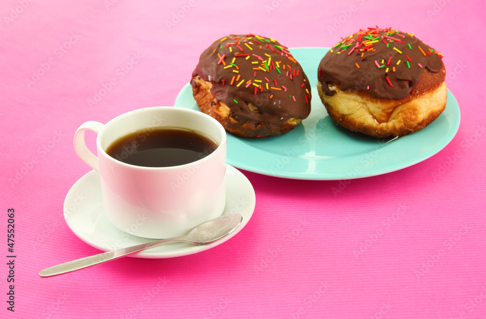 Tasty donuts on color plate on color background