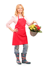 Poster - Mature florist holding a basket full of flowers