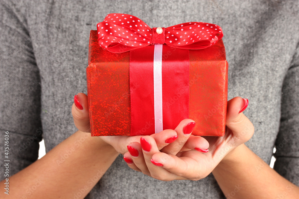 woman holds  box with gift on white background close-up