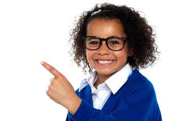 African primary girl showing the way to her classroom