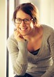 © Jacob Lund - Cheerful Woman with Eyeglasses Looking at You