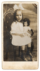 Wall Mural - old photo of little girl with doll toy