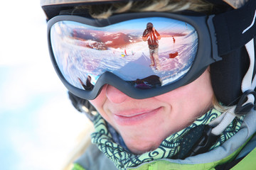 Wall Mural - Closeup portrait of a female skier standing on a skiing slope