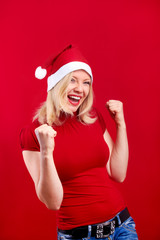 Wall Mural - pretty blonde woman wearing a christmas hat having fun