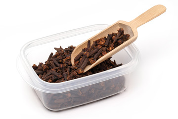 Poster - Carnations (spices) in a wooden spoon and plastic box