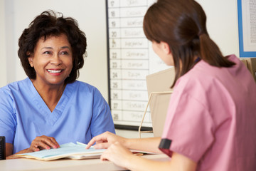 Wall Mural - Two Nurses In Discussion At Nurses Station