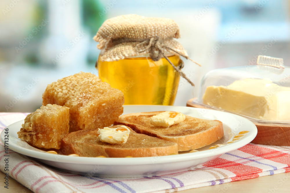 White bread toastwith honey on plate in cafe