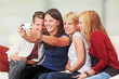 © Ingo Bartussek - 4 girls with smartphones on the sofa