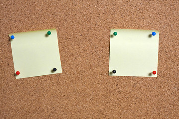 Yellow memo stick on cork board background